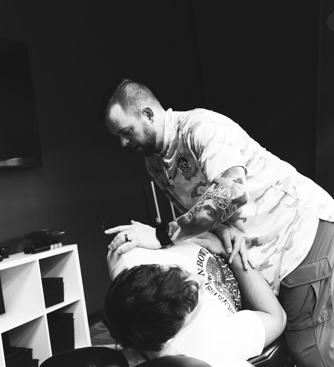 Dr. Fife adjusting a patient's upper back