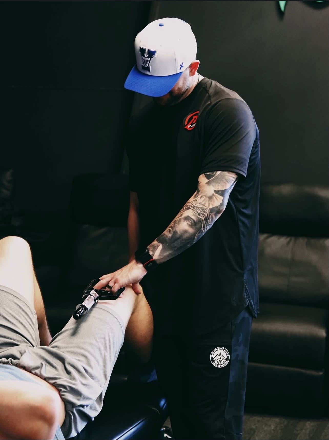 Dr. Fife treating a patient's knee with an adjusting tool